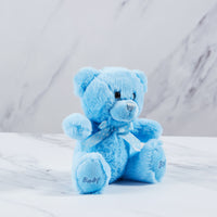 Blue baby boy teddy bear with blue and white polka dot tie. 