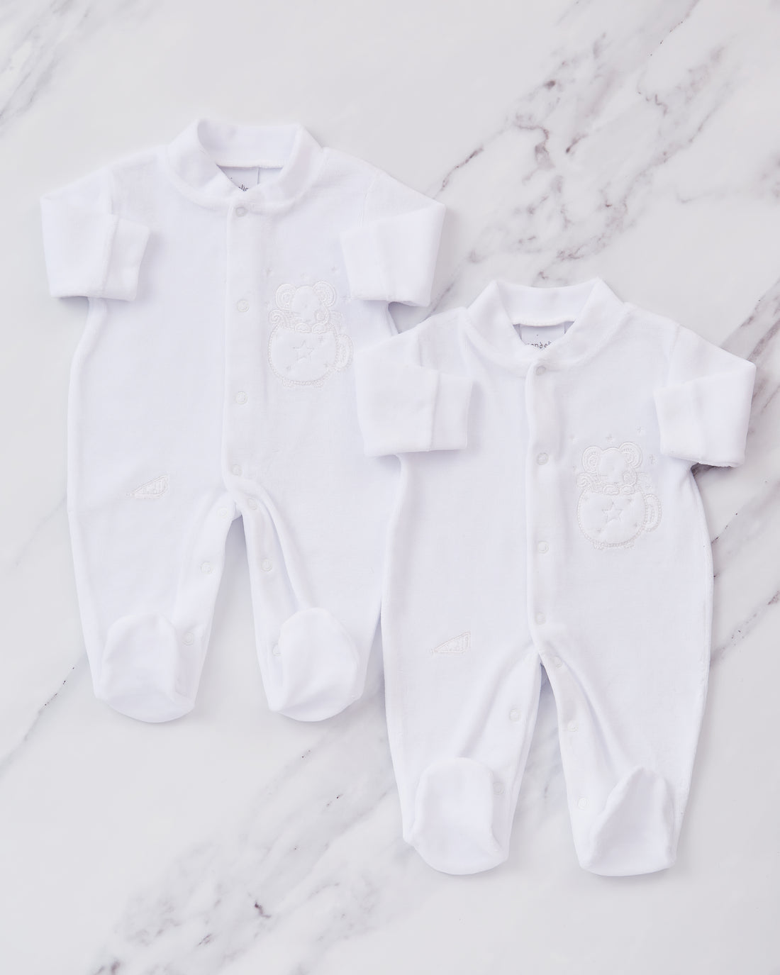 2 White embroidered sleepsuits. 