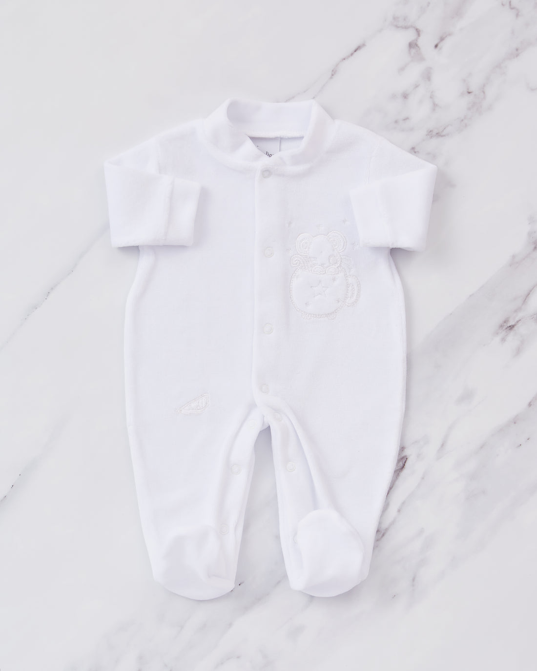 White embroidered baby sleepsuit. 
