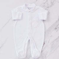 White embroidered baby sleepsuit.