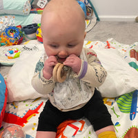 Baby using leopard print teether rattle 