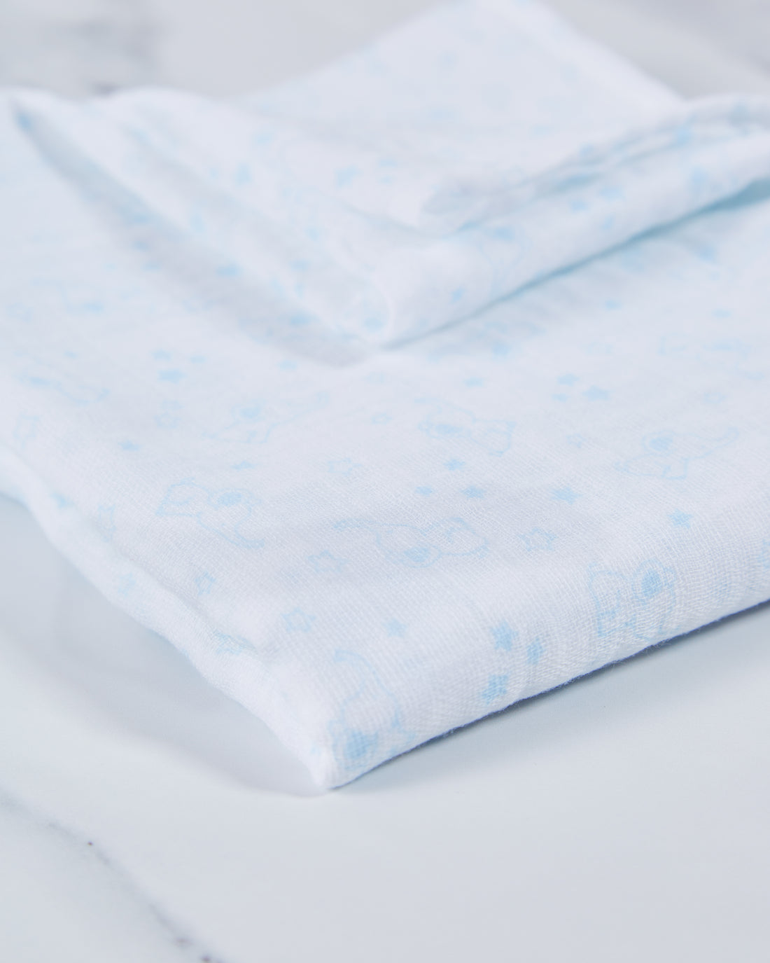 Blue cotton baby muslin with elephant print pattern. 