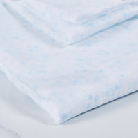 Blue cotton baby muslin with elephant print pattern. 