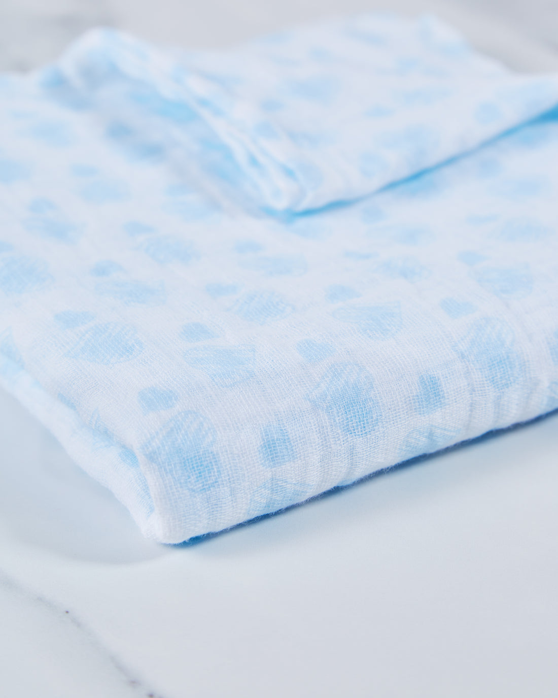 Blue cotton baby muslin with heart print pattern.