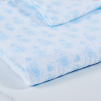 Blue cotton baby muslin with heart print pattern.