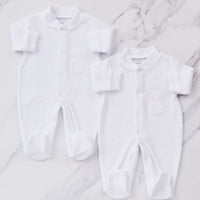 2 White embroidered sleepsuits. 