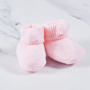 Pink acrylic baby booties.